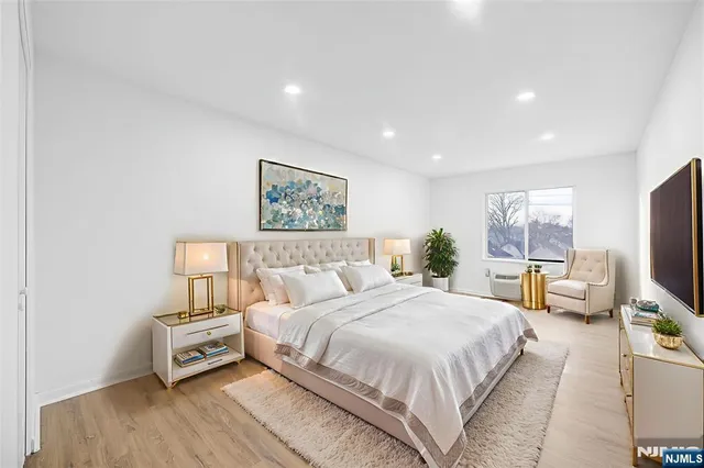 a bedroom with a bed and wooden floor