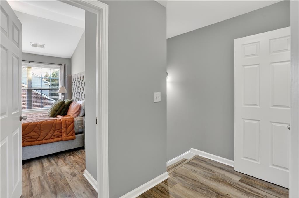 2555 Flat Shoals Road, Unit 1304 Atlanta, GA 30349 - Photo 11 of 27 a view of bedroom with furniture and wooden floor