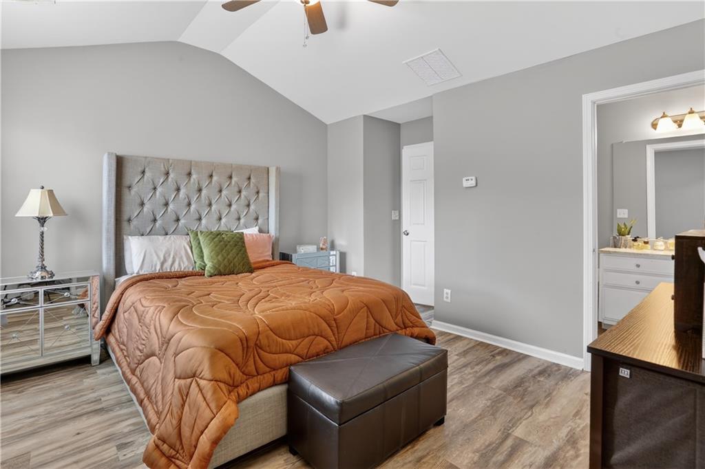 2555 Flat Shoals Road, Unit 1304 Atlanta, GA 30349 - Photo 13 of 27 a bedroom with a bed and wooden floor