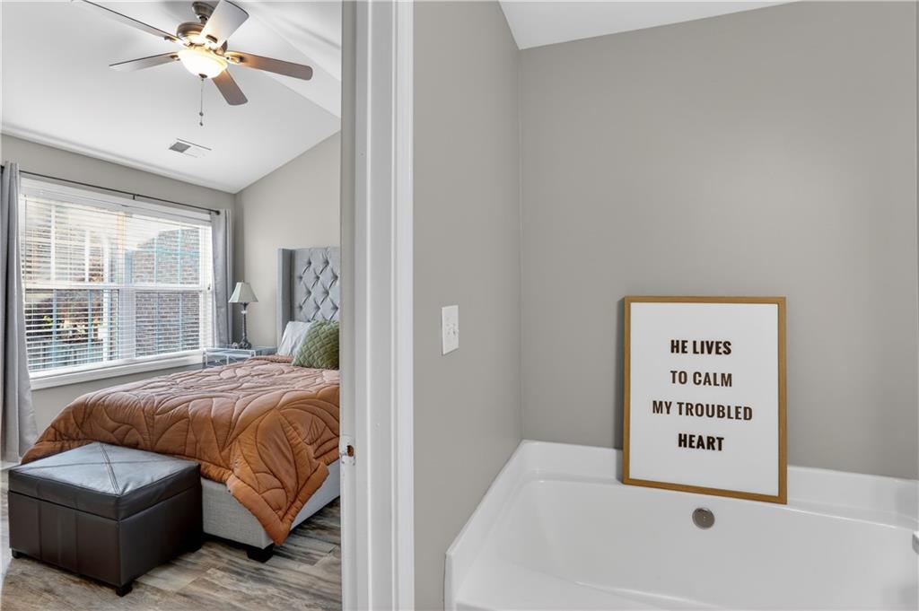 2555 Flat Shoals Road, Unit 1304 Atlanta, GA 30349 - Photo 14 of 27 a bedroom with a bed and a couch