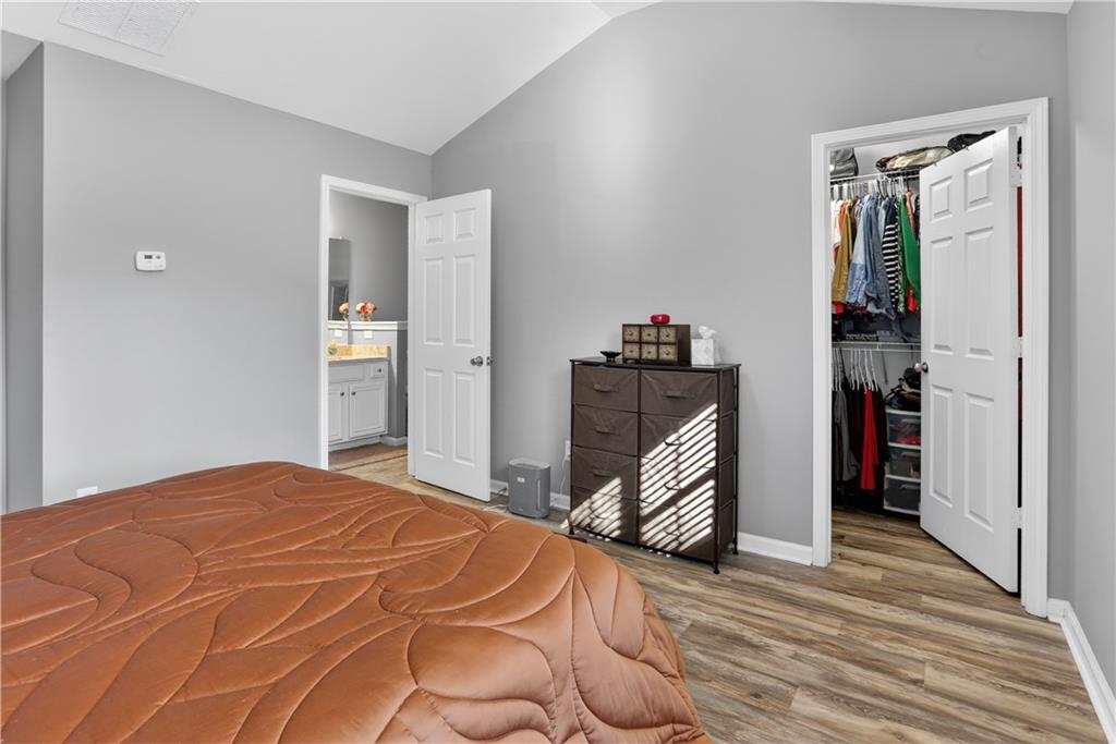 2555 Flat Shoals Road, Unit 1304 Atlanta, GA 30349 - Photo 15 of 27 a bedroom with a bed and a dresser