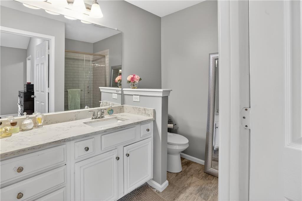 2555 Flat Shoals Road, Unit 1304 Atlanta, GA 30349 - Photo 16 of 27 a bathroom with a granite countertop sink and a mirror