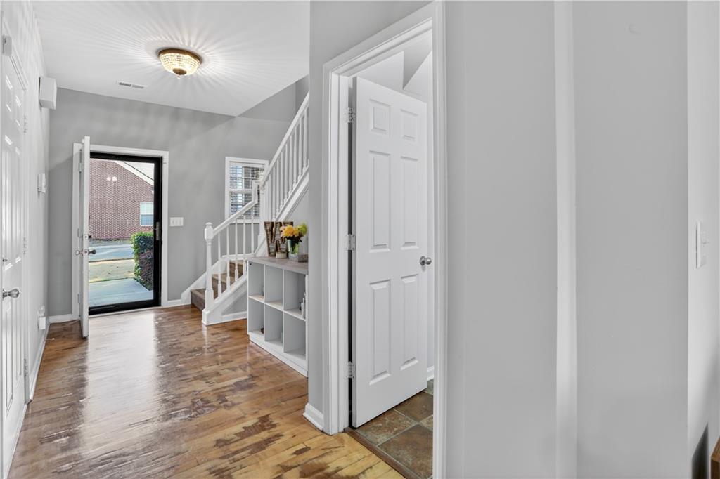 2555 Flat Shoals Road, Unit 1304 Atlanta, GA 30349 - Photo 19 of 27 a view of a hallway with wooden floor and a livingroom