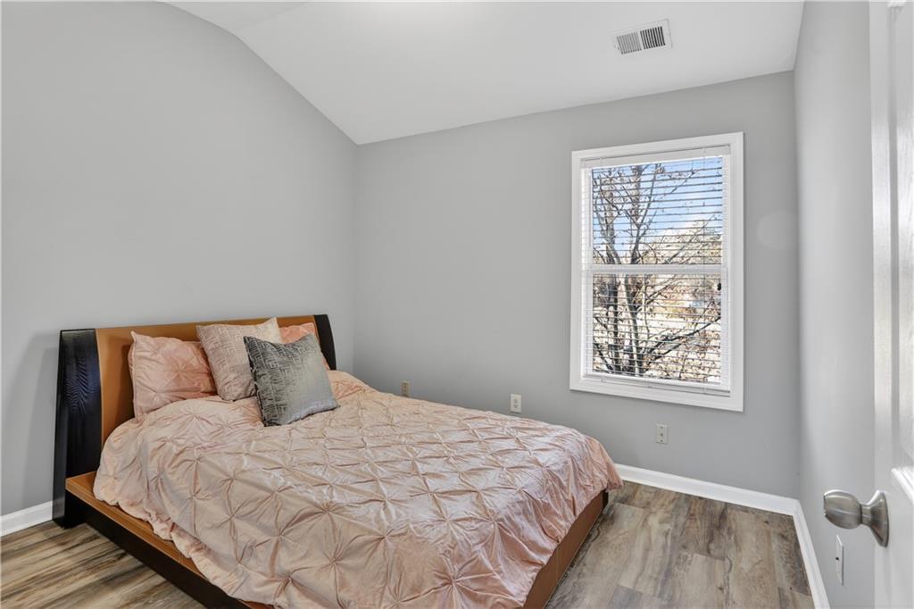 2555 Flat Shoals Road, Unit 1304 Atlanta, GA 30349 - Photo 20 of 27 a large bed sitting in a bedroom next to a window