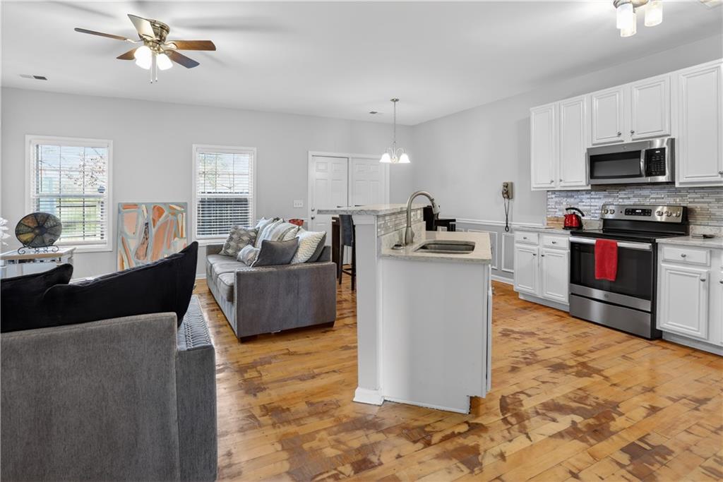 2555 Flat Shoals Road, Unit 1304 Atlanta, GA 30349 - Photo 4 of 27 a living room with furniture and a flat screen tv