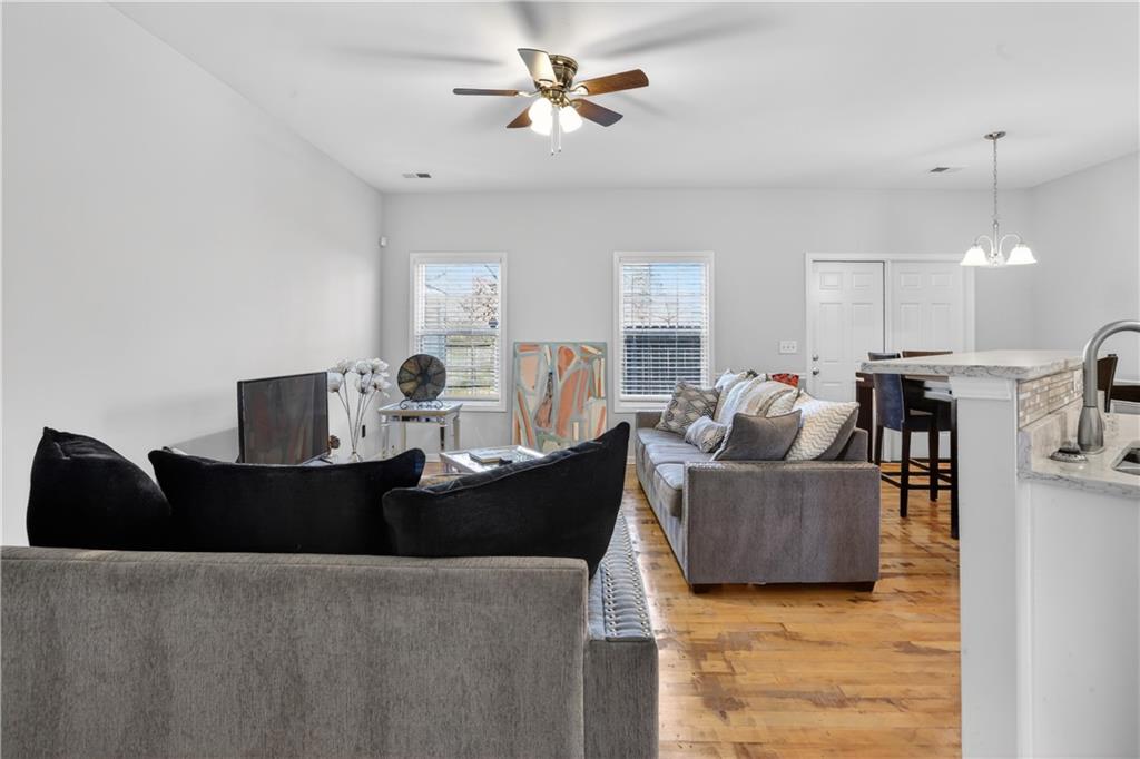 2555 Flat Shoals Road, Unit 1304 Atlanta, GA 30349 - Photo 7 of 27 a living room with furniture and a chandelier