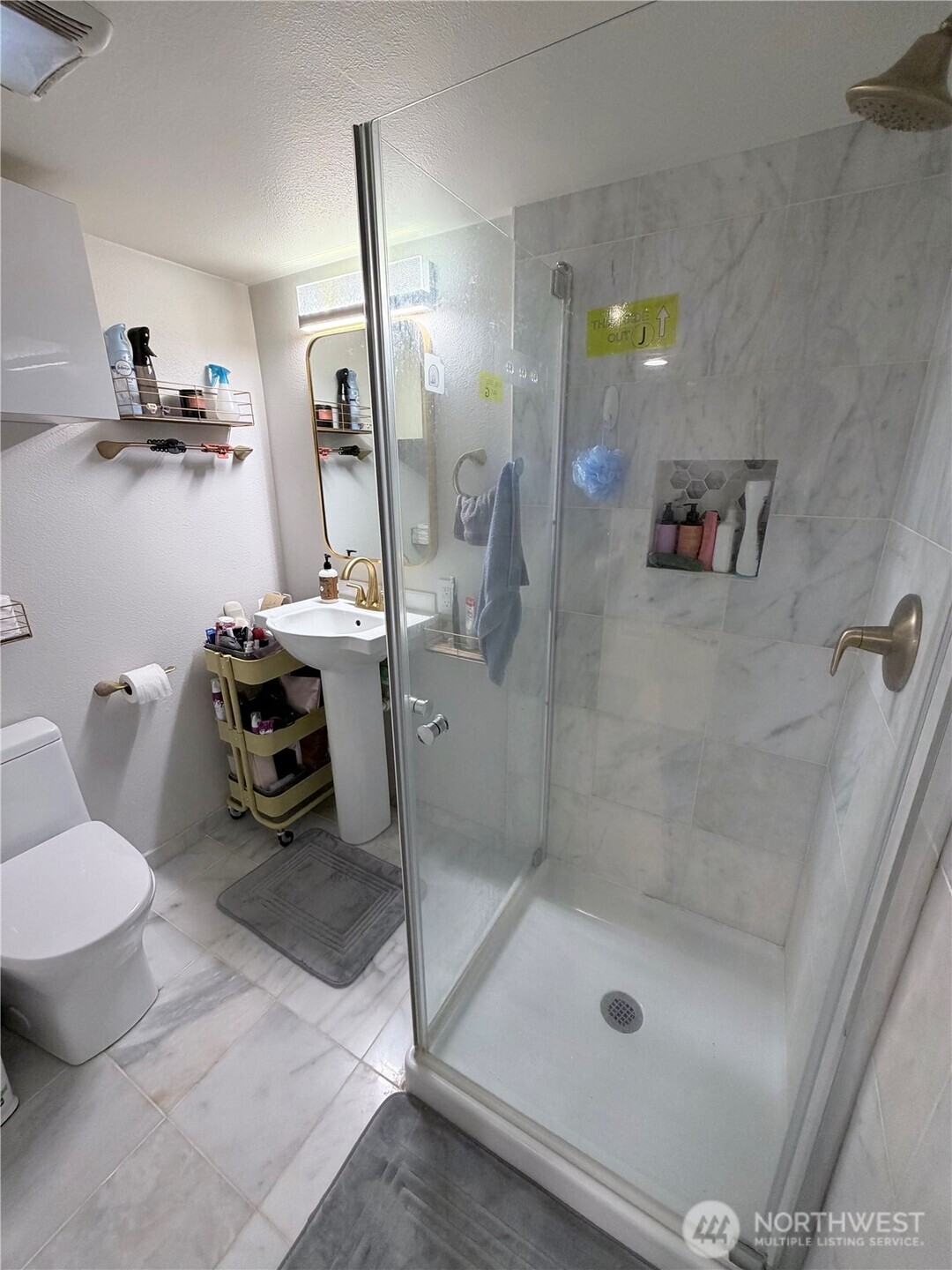 3217 East Madison Street Seattle, WA 98112 - Photo 31 of 40 a bathroom with a sink and mirror