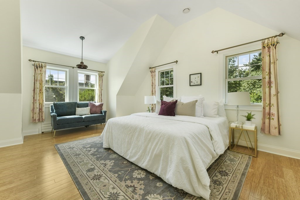 46 Spring Street, Unit 2 Somerville, MA 02143 - Photo 11 of 22 a spacious bedroom with a bed a couch and a window
