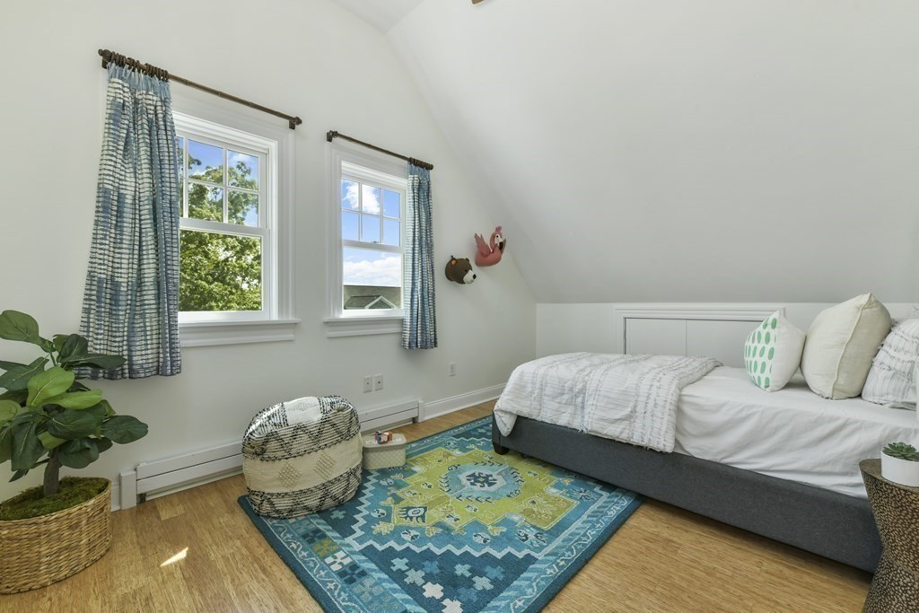 46 Spring Street, Unit 2 Somerville, MA 02143 - Photo 15 of 22 a bedroom with a bed and a couch