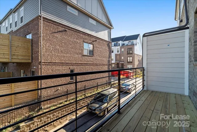 a view of balcony with wooden floor and fence