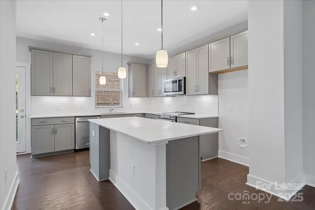 a kitchen with a sink stove and cabinets