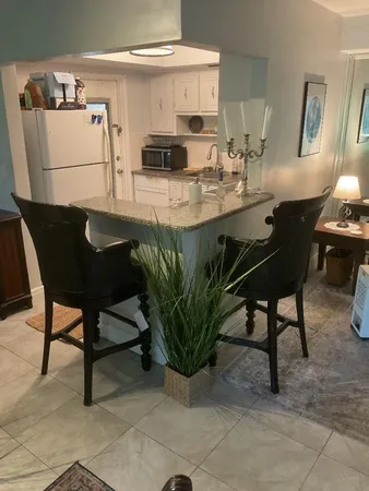 a kitchen with granite countertop a sink stove and cabinets