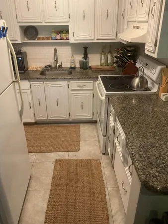 a living room with furniture a rug and a window