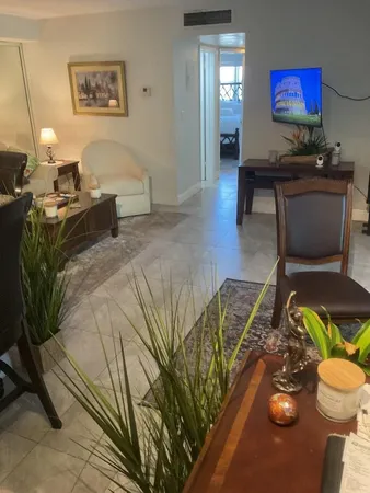 a bathroom with a sink a toilet and shower curtain