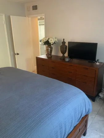 a white toilet sitting next to a shower curtain