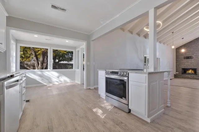 a view of a kitchen with furniture and a fireplace