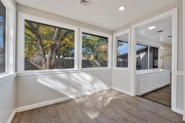 a view of a living room with large windows