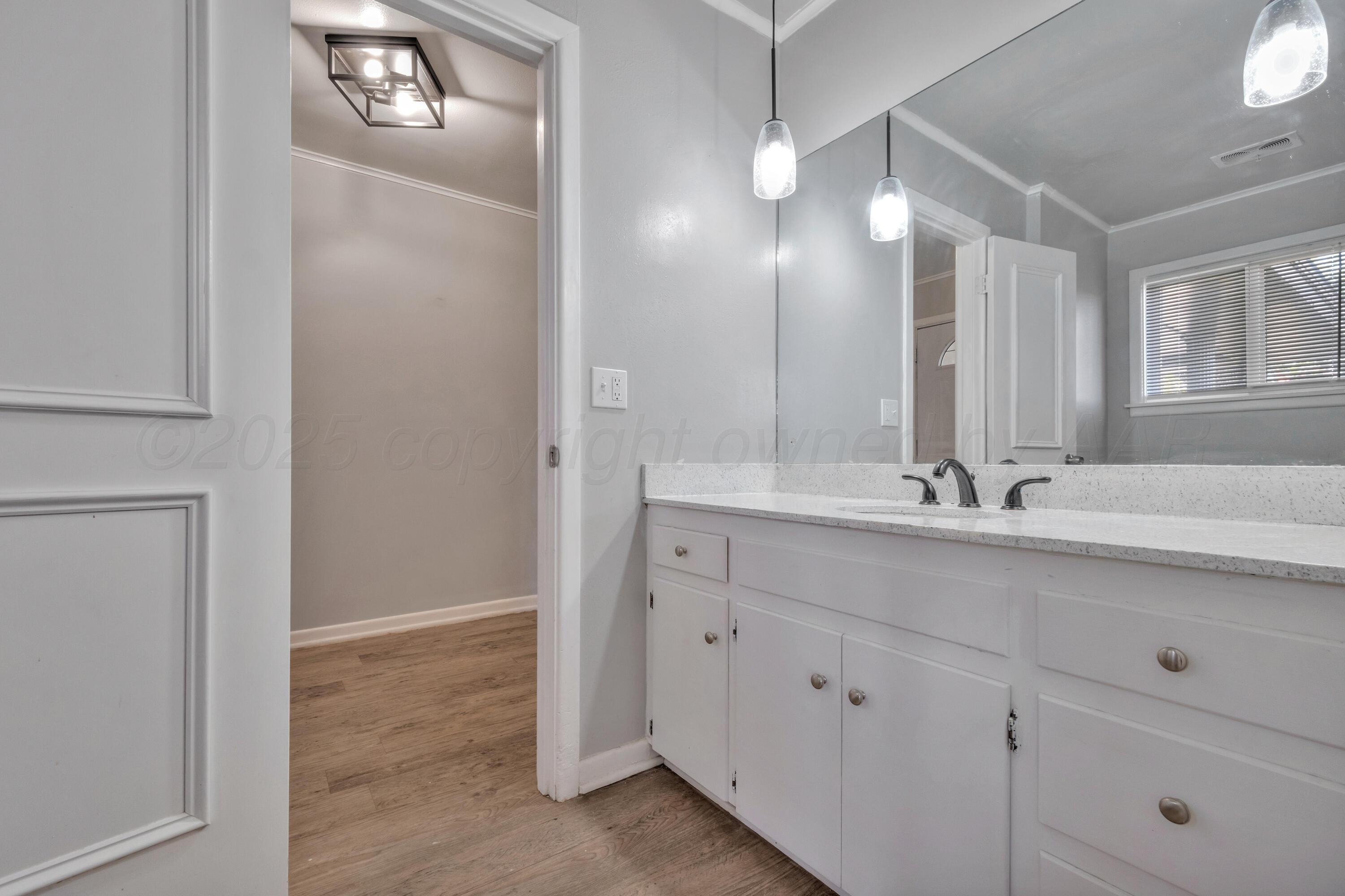 3700 Paramount Boulevard Amarillo, TX 79109 - Photo 20 of 40 a bathroom with double vanity sink and a mirror