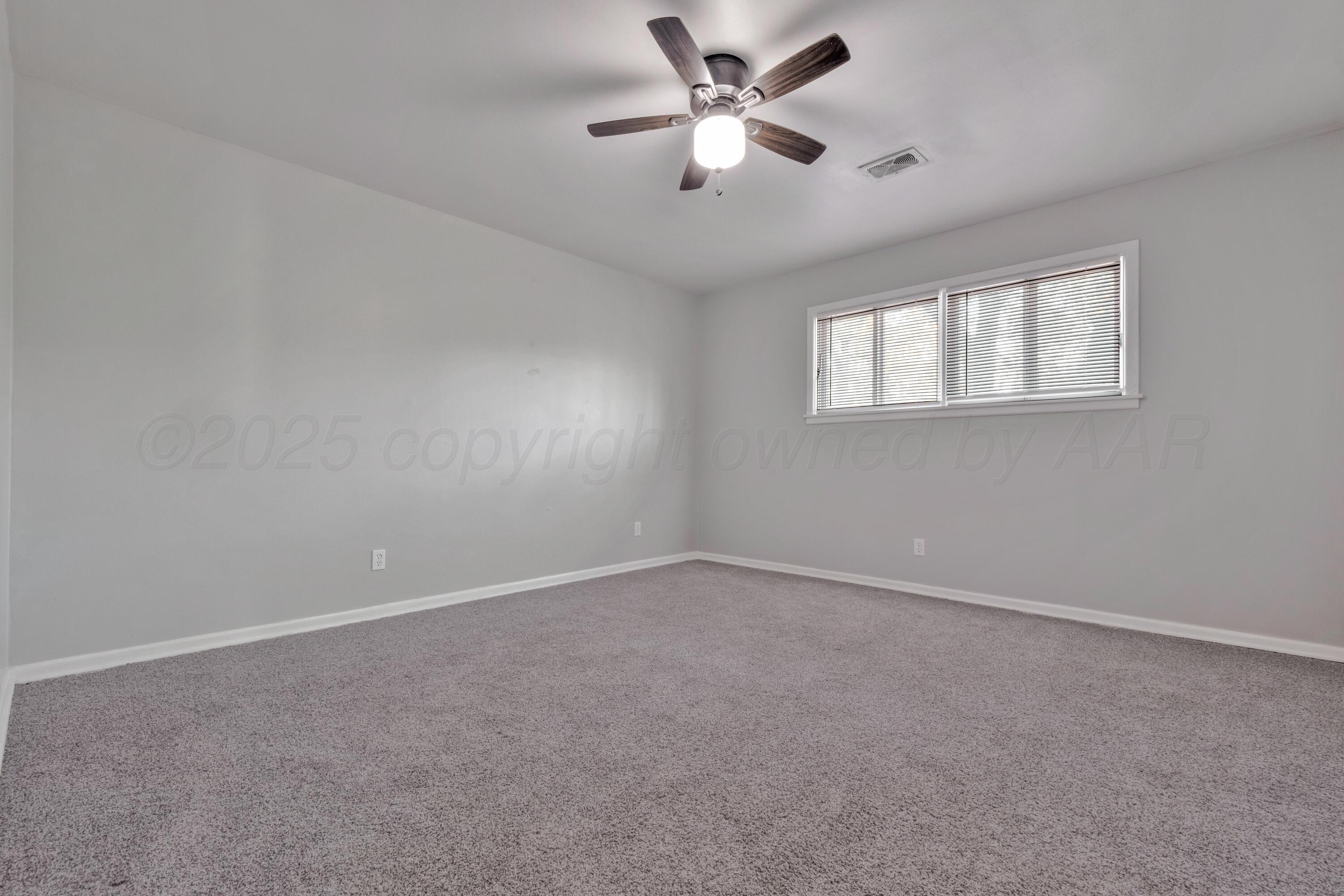 3700 Paramount Boulevard Amarillo, TX 79109 - Photo 29 of 40 an empty room with a window and a fan