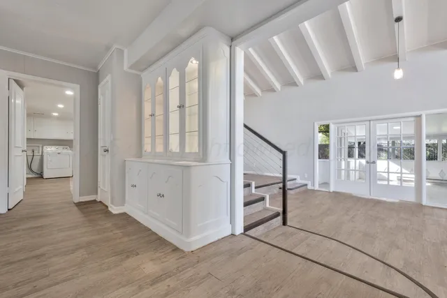 a view of an entryway with wooden floor