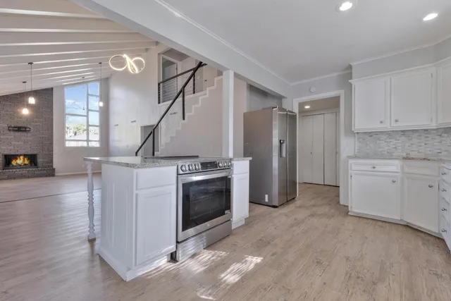 a kitchen with cabinets and stainless steel appliances