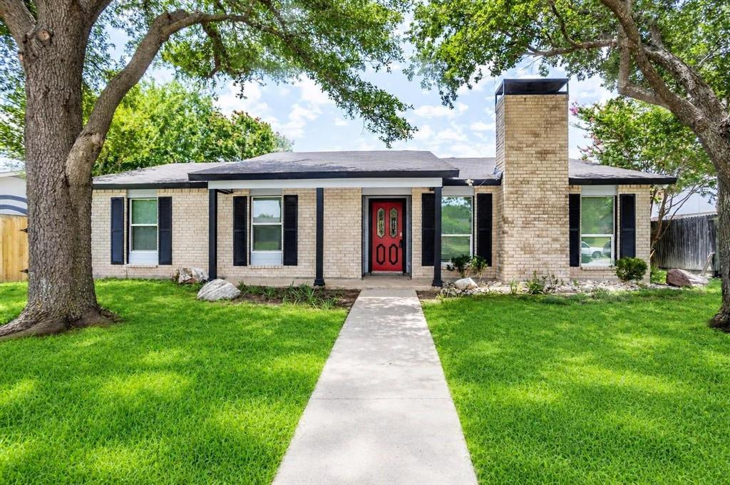 Front entry has accent door, nice shade trees.  Chimney has already got the cap in place.  Grass is still trying to cover some bare spots.  