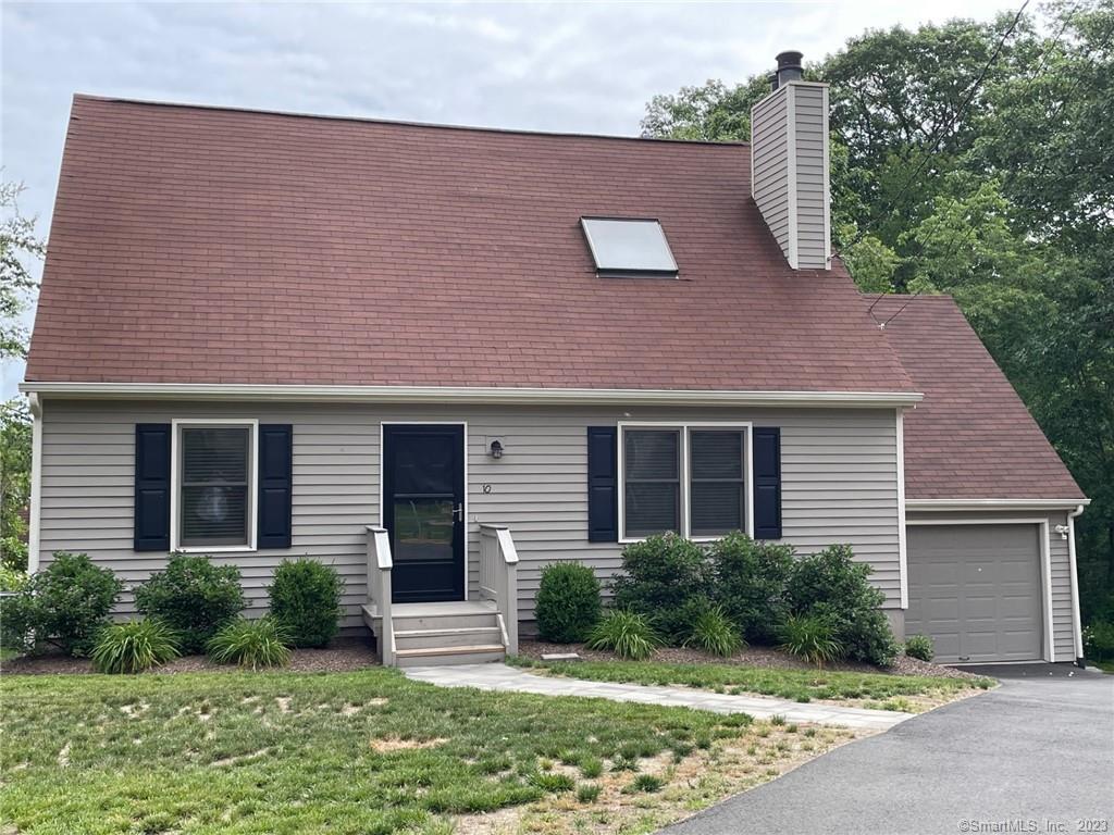 10 Copper Ridge Circle, Unit 10 Guilford, CT 06437 - Photo 1 of 1 a front view of a house with garden