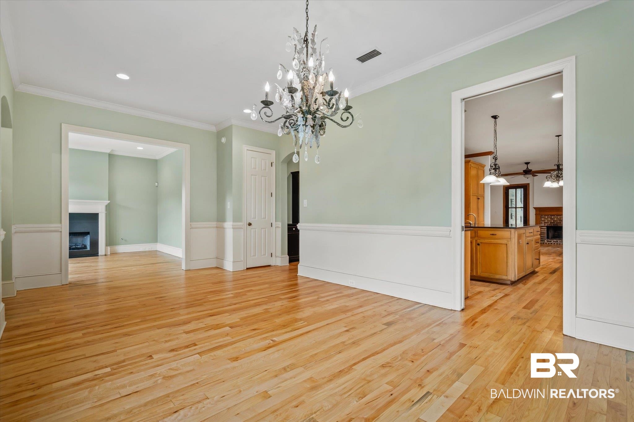 812 Country Club Court Mobile, AL 36609 - Photo 3 of 34 Unfurnished dining area featuring ornamental molding, a notable chandelier, and light hardwood / wood-style floors