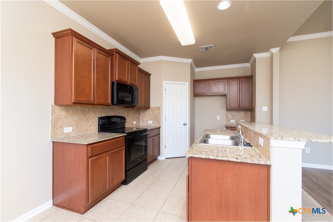 8020 Hawthorn Temple, TX 76502 - Photo 16 of 21 a kitchen with a sink stove top oven and microwave