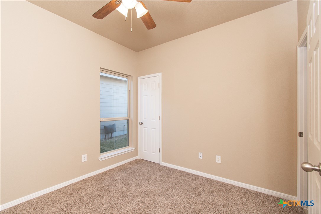 8020 Hawthorn Temple, TX 76502 - Photo 4 of 21 an empty room with a ceiling fan and a window