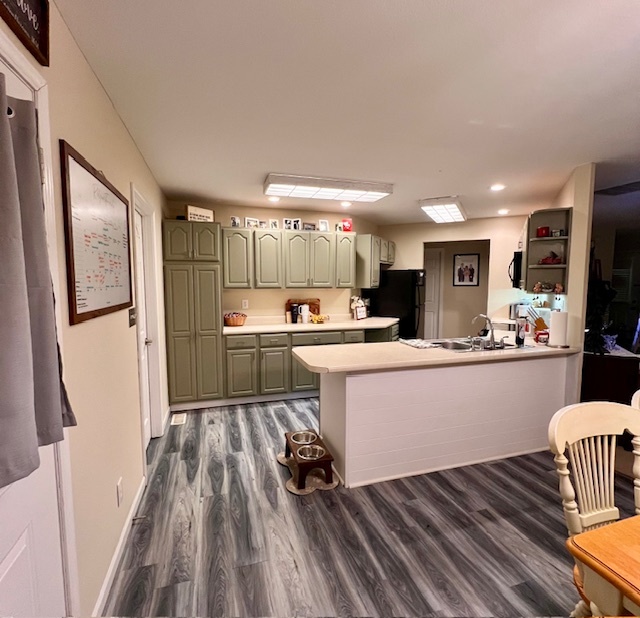 409 East Congress Avenue Rantoul, IL 61866 - Photo 6 of 20 a kitchen with cabinets wooden floor and stainless steel appliances