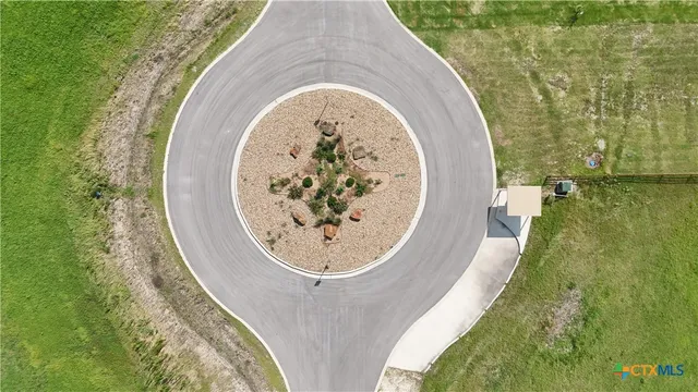 an aerial view of a house with outdoor space and a lake view