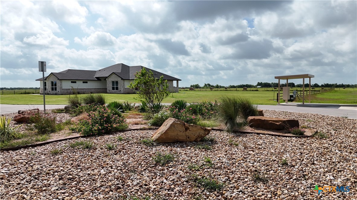 Tbd Tbd Cougar Lane Lott, TX 76656 - Photo 4 of 9 a view of a garden with a table and chairs under an umbrella