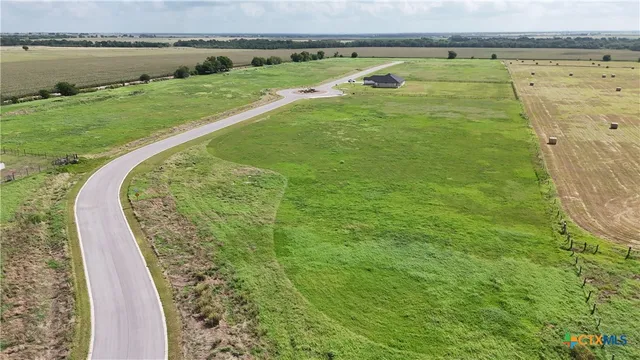 a view of a swimming pool with a garden and seating area