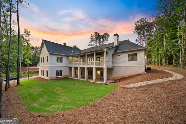 a view of an empty room with a fireplace and a window
