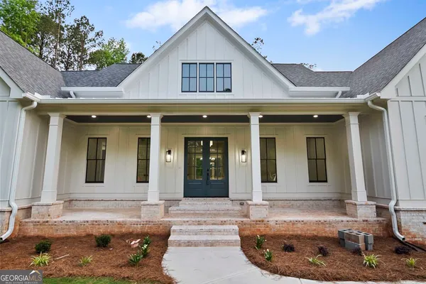 a living room with a fireplace and a floor to ceiling window