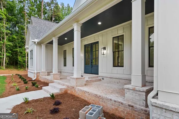 a view of an empty room with wooden floor fireplace and a window