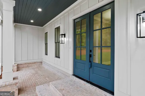 a view of a balcony with blue floor to ceiling window and wooden floor