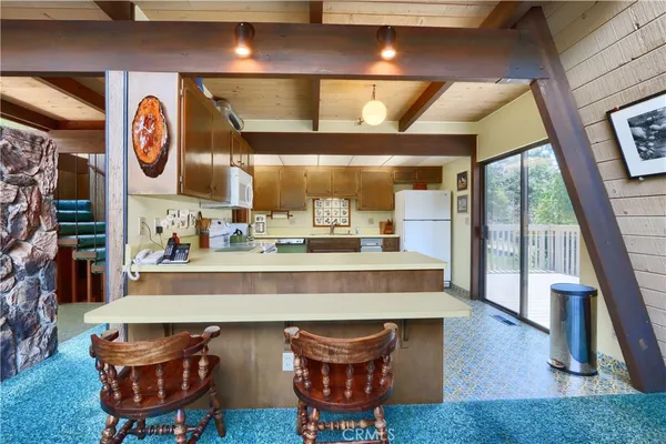 a kitchen with stainless steel appliances a refrigerator and a counter