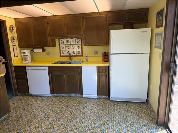 a kitchen with a sink cabinets and window