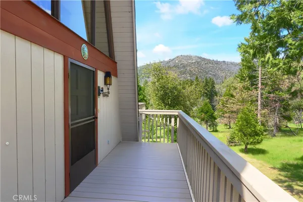 a view of balcony with wooden floor and fence