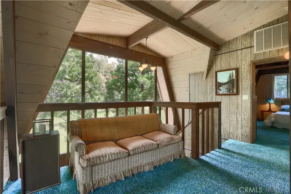 a bedroom with a bed window and a chair