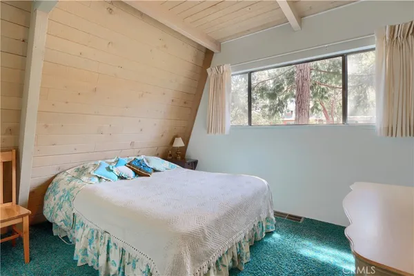 a bedroom with bed and window