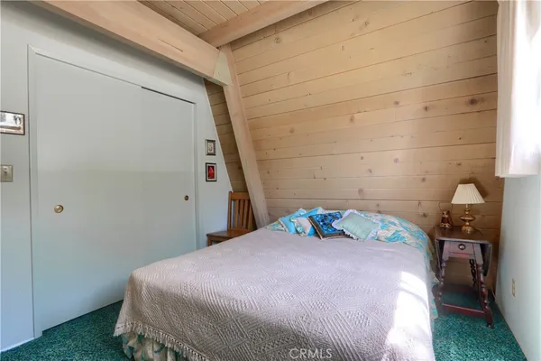 a living room with fireplace furniture and a large window