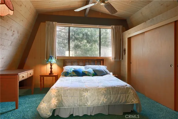 a living room with lots of furniture and a large window