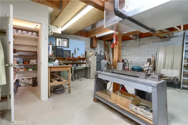 an aerial view of a house with a yard and large trees