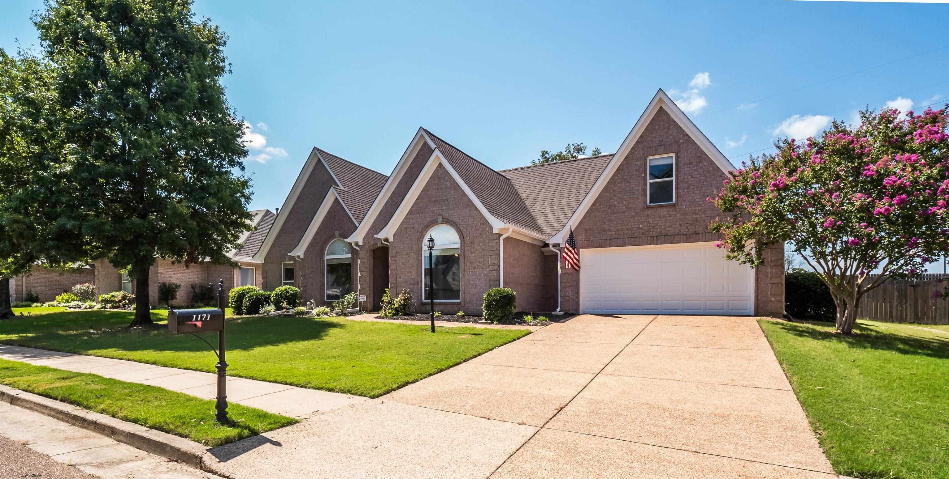a front view of house with yard and green space