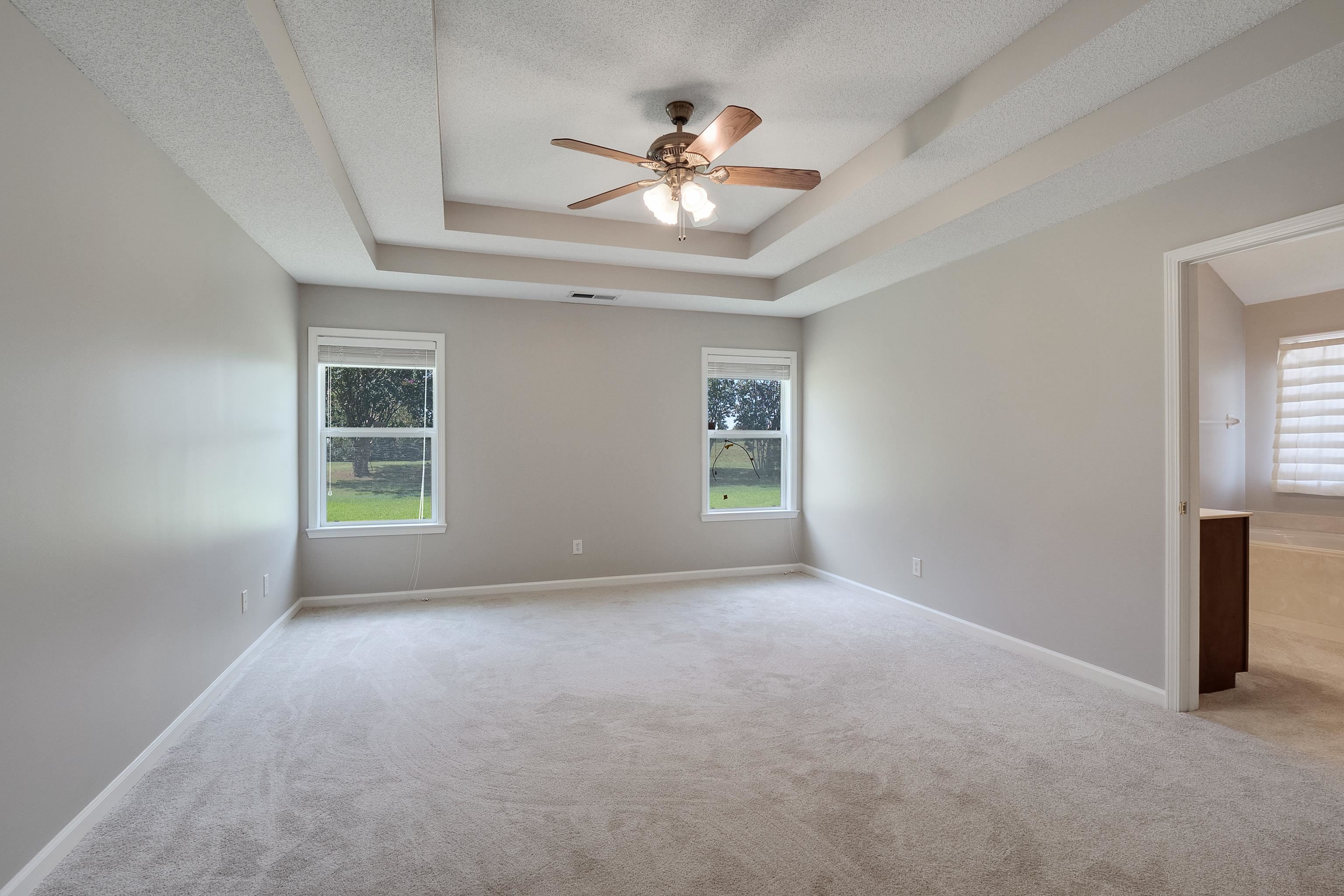 1171 Macon Hall Road Cordova, TN 38018 - Photo 15 of 35 an empty room with windows and ceiling fan