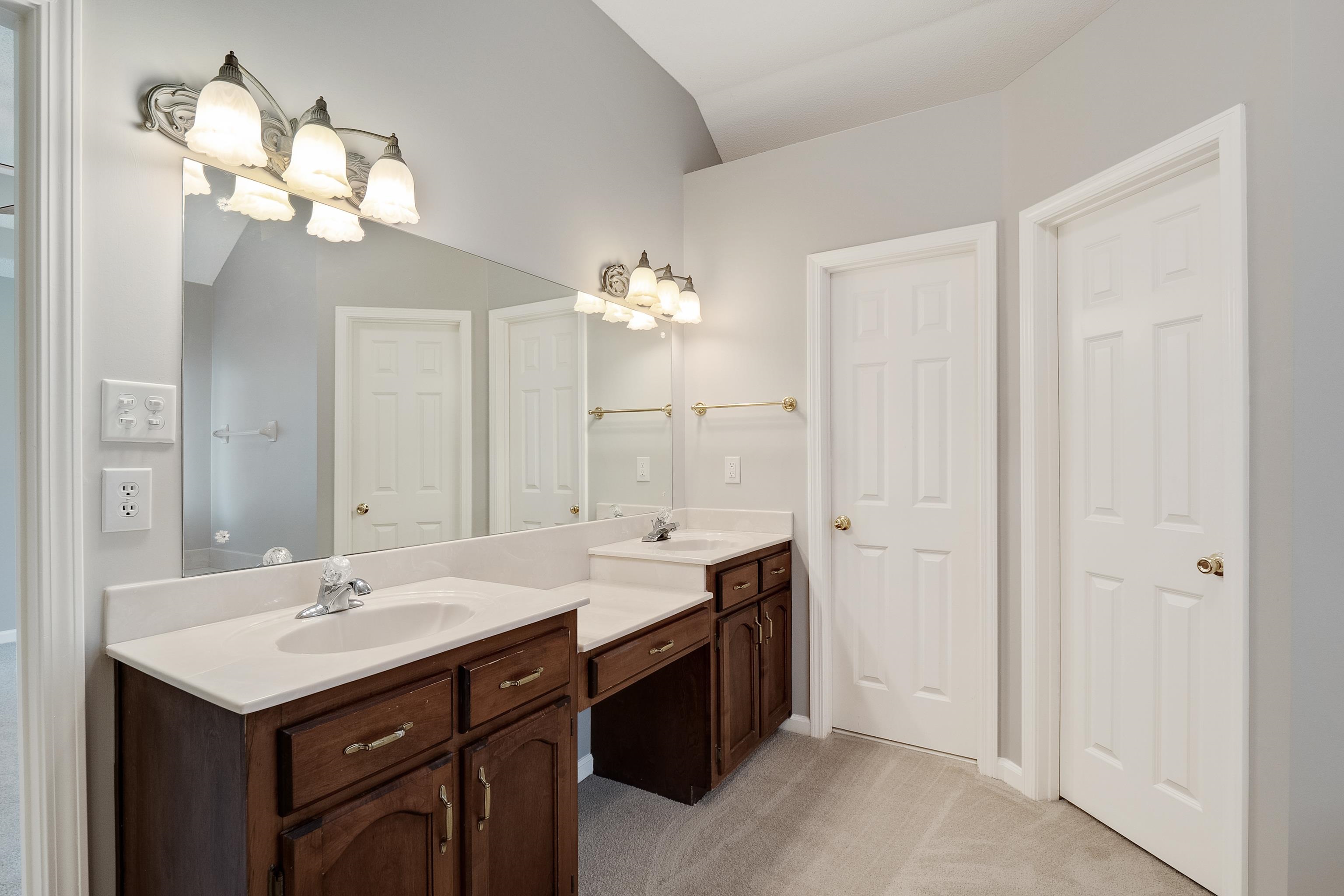 1171 Macon Hall Road Cordova, TN 38018 - Photo 18 of 35 a bathroom with a sink a vanity and a mirror