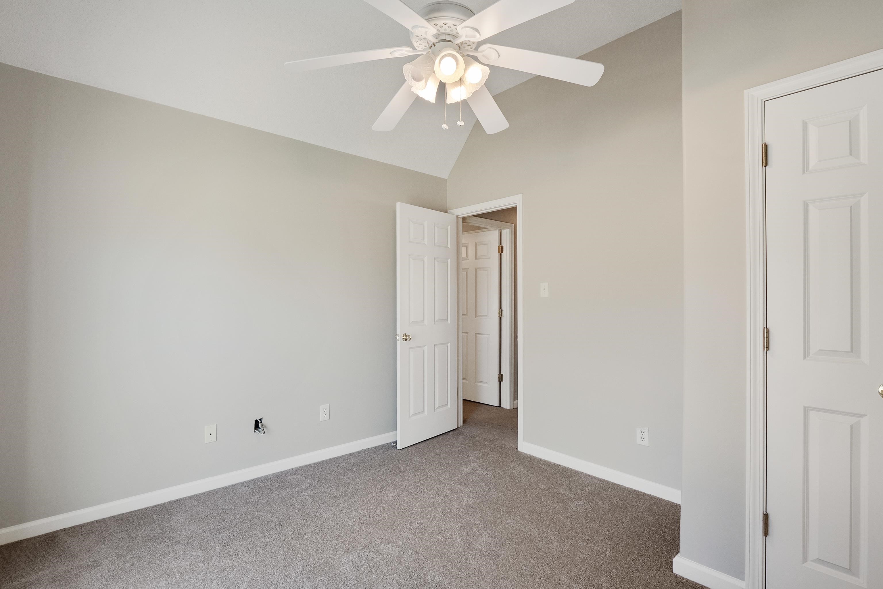 1171 Macon Hall Road Cordova, TN 38018 - Photo 21 of 35 an empty room with a chandelier fan and closet area